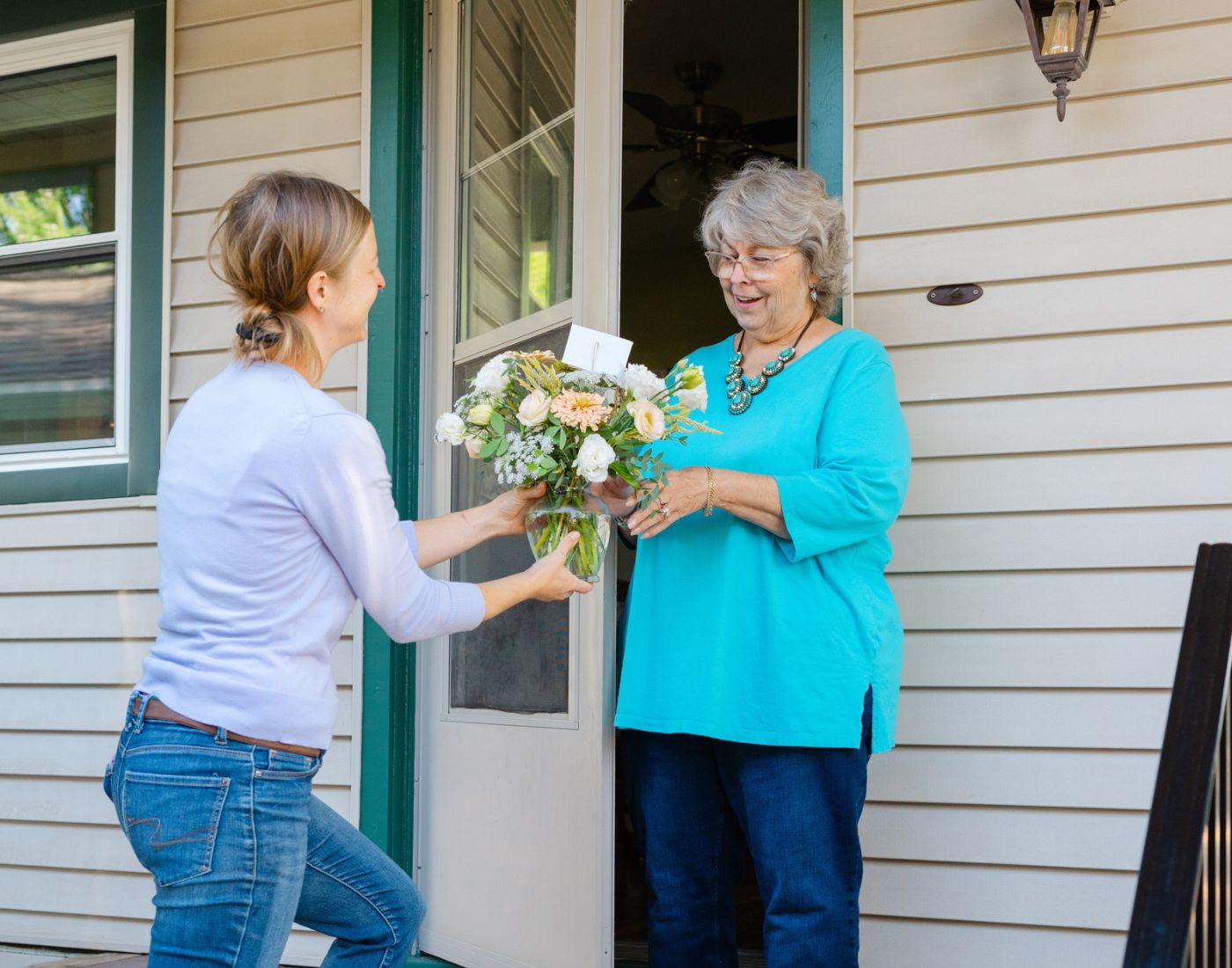 A vased floral arrangement being delivered to the door of a West Bend home